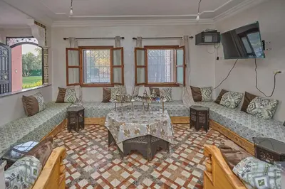 a living room with couches and a table at Dar Hma in Marrakech