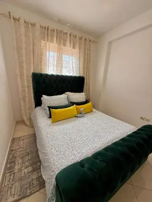 a bedroom with a large bed with yellow pillows at Marrakech stay in Marrakech