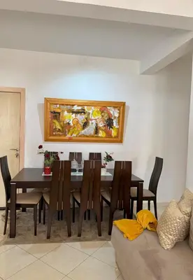 a dining room with a table and a painting on the wall at Marrakech stay in Marrakech