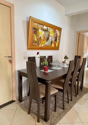 a dining room table with chairs and a painting on the wall at Marrakech stay in Marrakech