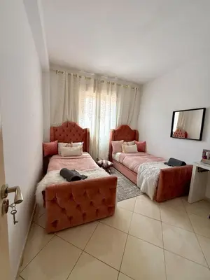 a bedroom with two beds and a couch in it at Marrakech stay in Marrakech