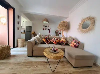 a living room with a couch and a table at Peaceful one terrace suite, gueliz in Marrakech