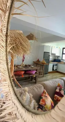 a living room with a couch and a kitchen at Peaceful one terrace suite, gueliz in Marrakech