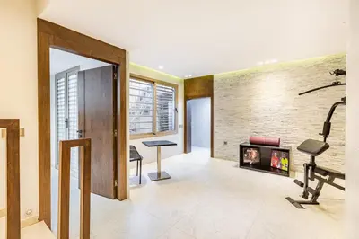a living room with a fireplace and exercise equipment at Villa Zineb Confort, design et sérénité in Marrakech