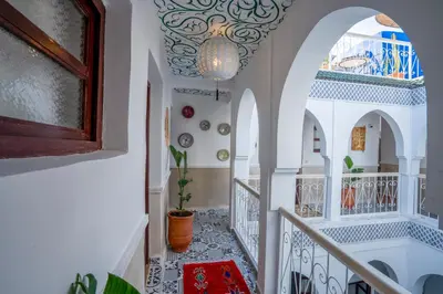 a staircase in a house with a tile floor and a chandelier at Riad Loriental And Spa in Marrakech