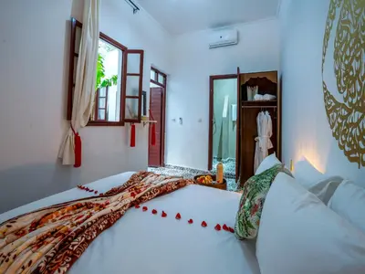 a bedroom with a bed with a blanket on it at Riad Loriental And Spa in Marrakech