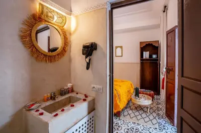a bathroom with a sink and a mirror at Riad Loriental And Spa in Marrakech
