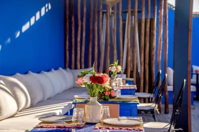 a table with a vase of flowers on it at Riad les palmiers de la medina in Marrakech