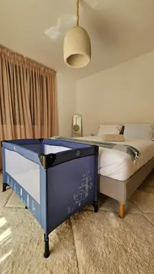 a bedroom with a blue bed in a room at Votre Villa Soleil et Chaleureuse in Marrakech