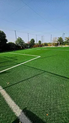 a soccer field with green grass and a goal at Votre Villa Soleil et Chaleureuse in Marrakech