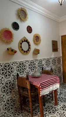 a dining room with a table and plates on the wall at traditional apartment in Marrakech