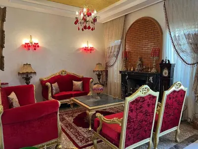 a living room with red chairs and a table at Villa in Marrakesh Targa with swimmingpool in Marrakech