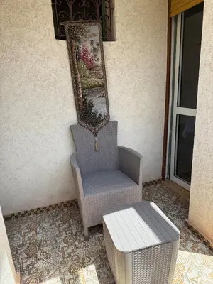 a chair and a mirror on the side of a house at Villa in Marrakesh Targa with swimmingpool in Marrakech