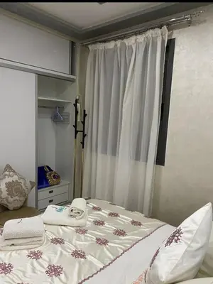 a bedroom with a bed and a window with towels at Séjour agréable à marrakech in Marrakech
