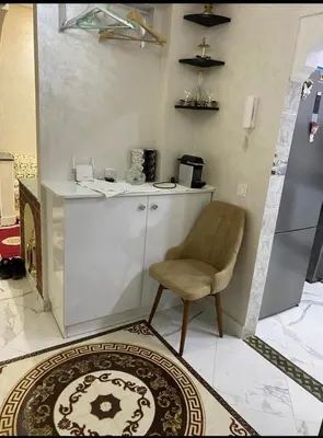a kitchen with a counter and a chair in a room at Séjour agréable à marrakech in Marrakech