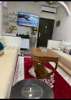 a living room with a table and a couch at Séjour agréable à marrakech in Marrakech
