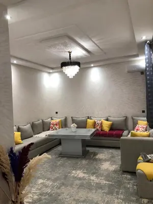 a living room with a couch and a table at Appartement hay mabroka in Marrakech