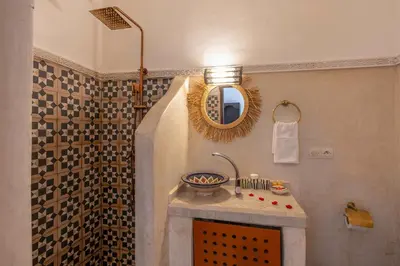 a bathroom with a sink and a mirror at Riad Jowara in Marrakech