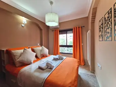 a bedroom with a large bed with towels on it at Appartement cosy au cœur de la medina in Marrakech