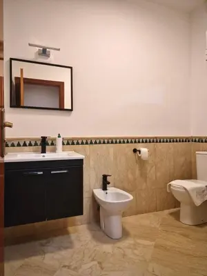 a bathroom with a sink and a toilet and a mirror at Appartement cosy au cœur de la medina in Marrakech