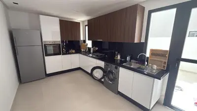 a large kitchen with a washer and dryer in it at Duplex Menara Garden 2 in Marrakech