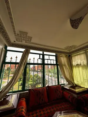 a living room with a couch in front of a window at Oum rabiaa in Marrakech
