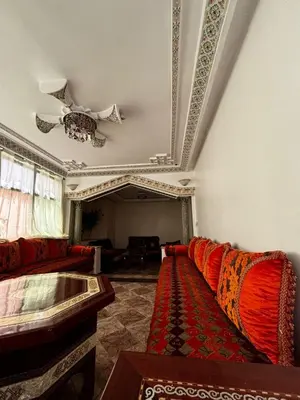 a living room with a couch and a ceiling at Oum rabiaa in Marrakech