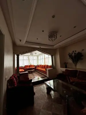 a large living room with couches and a large window at Oum rabiaa in Marrakech