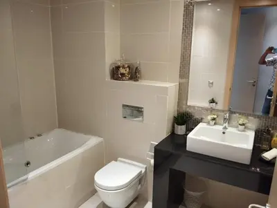 a bathroom with a white toilet and a sink at Appartement prestigia golf in Marrakech