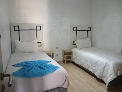 a bedroom with two beds with blue towels on them at Appartement prestigia golf in Marrakech