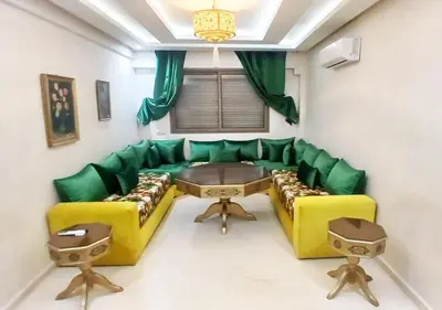 a living room with a green couch and a table at duplex prestige Gueliz in Marrakech