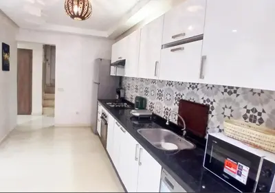 a kitchen with a sink and a counter top at duplex prestige Gueliz in Marrakech