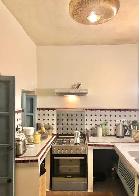 a kitchen with a stove and a counter top at Riad HØBÖ-CHIC privé Medina rooftop WI-FI Fibre in Marrakech