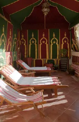 a room with chairs and paintings on the walls at Appartement Andalou in Marrakech