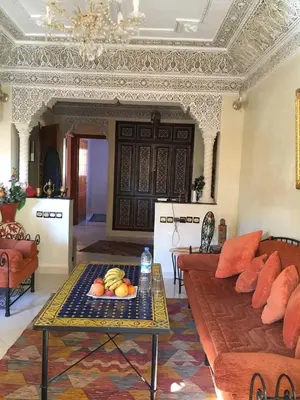 a living room with a couch and a table with fruit on it at Appartement Andalou in Marrakech