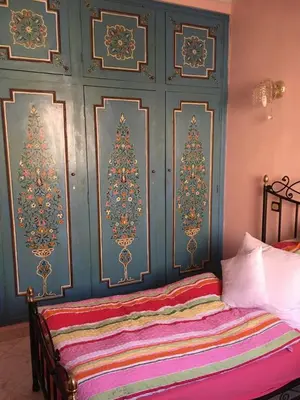 a bedroom with two christmas trees on the wall at Appartement Andalou in Marrakech