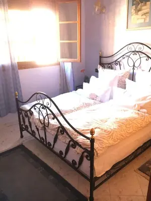 a bedroom with a large bed with white pillows at Appartement Andalou in Marrakech