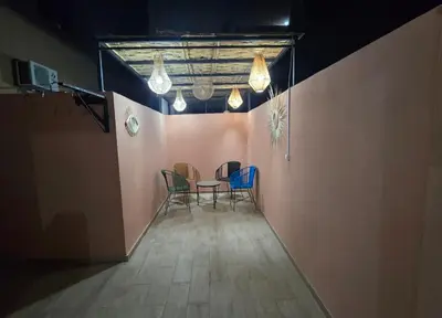 a dining room with chairs and a table and lights at Appartement Gueliz in Marrakech