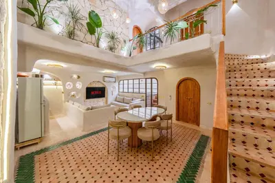 a living room with a table and a couch at DarNiama - 3 Suites & Private Pool - Gueliz Center in Marrakech