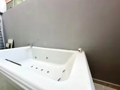 a white bath tub in a room with a wall at Chic duplex luxury3suites et wi-fi in Marrakech