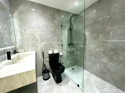 a bathroom with a toilet and a glass shower at Chic duplex luxury3suites et wi-fi in Marrakech