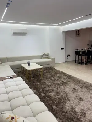 a living room with white couches and a table at Chic duplex luxury3suites et wi-fi in Marrakech