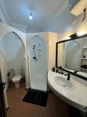 a bathroom with a sink and a toilet and a mirror at Appartement typique Marrakech in Marrakech