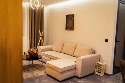 a living room with a couch and a table at Cocon Stylé & Spacieux au Cœur de Ville in Marrakech