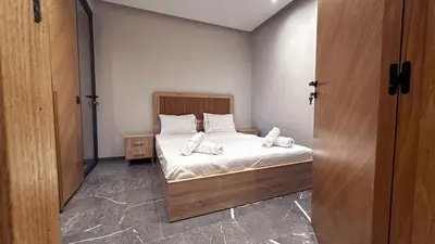 a bedroom with a bed with white sheets and pillows at Le Cocon 28 Spacieux & Stylé au Cœur de la Ville in Marrakech