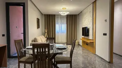 a dining room with a table and chairs and a television at Le Cocon 28 Spacieux & Stylé au Cœur de la Ville in Marrakech