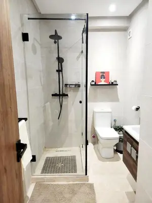 a bathroom with a shower and a toilet at Bohemian Chic Apartment in Guéliz - Pool View in Marrakech