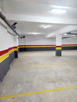 an empty parking garage with colorful stripes on the walls at Bohemian Chic Apartment in Guéliz - Pool View in Marrakech