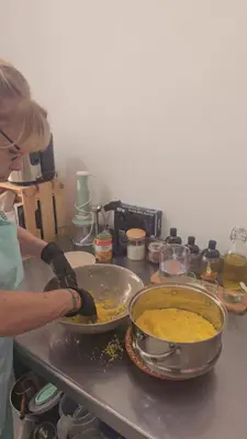a woman is preparing food in a kitchen at atelier de cuisine in Marrakech