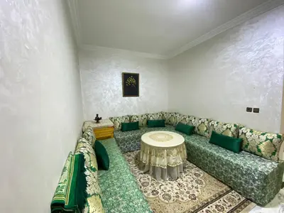 a living room with a couch and a table at Cosy, Calm Apartment - Wi-Fi, AC & NETFLIX in Marrakech